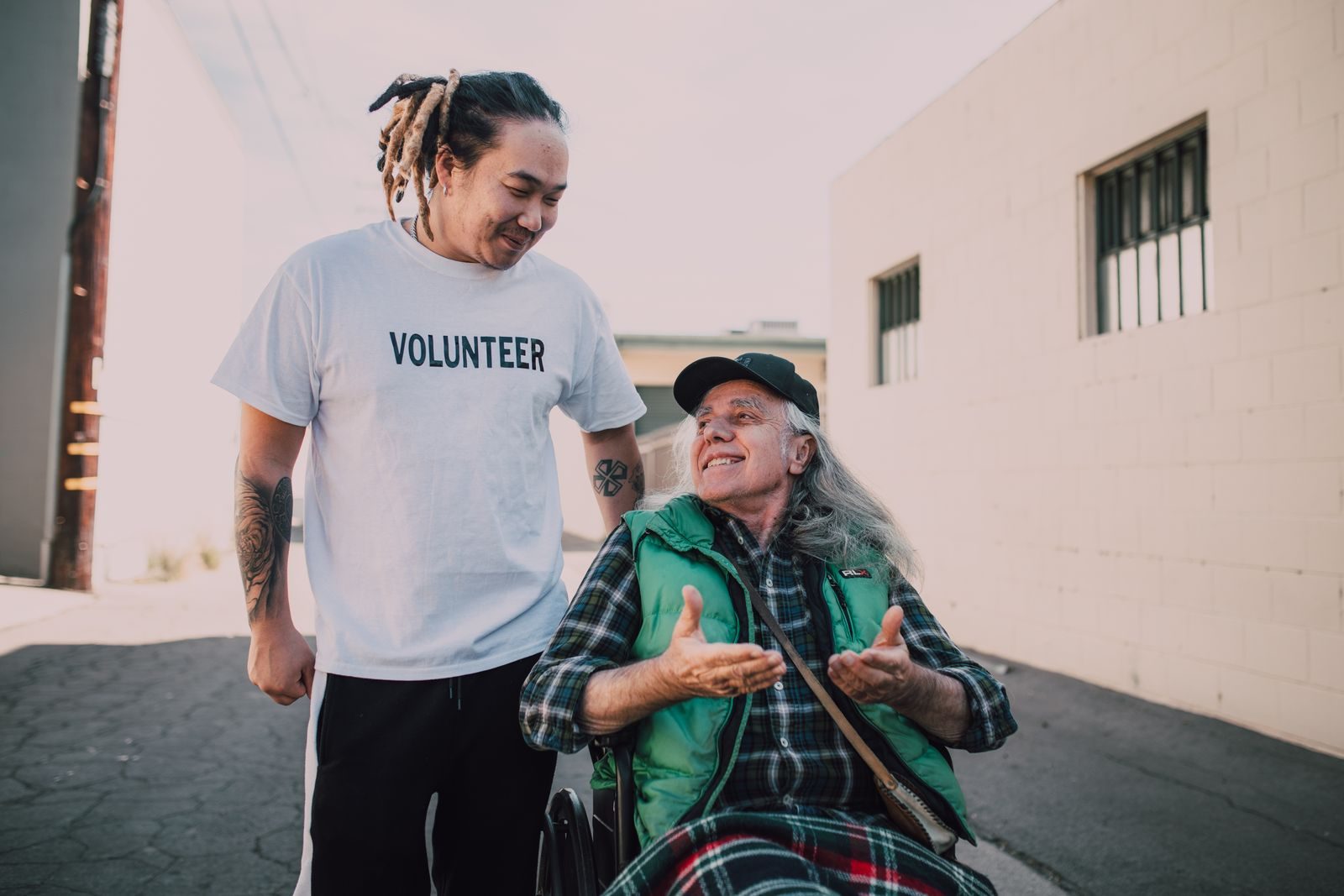 A volunteer helping a senior passenger in a wheelchair
